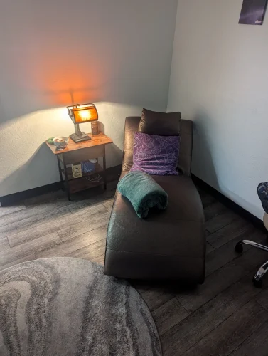 a comfortable couch and an end table with a lamp for our therapy room